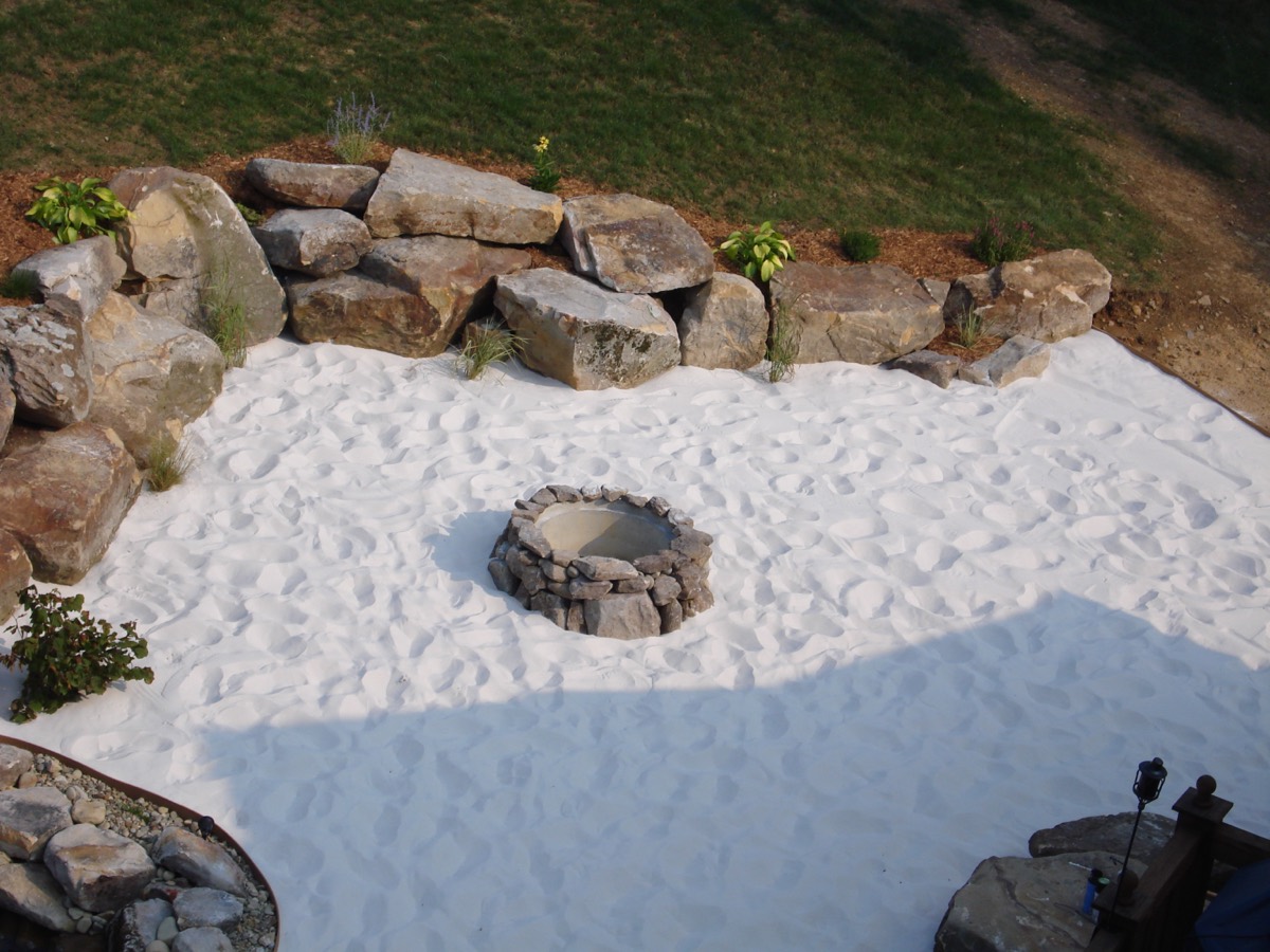 Beach-sand patio with a firepit