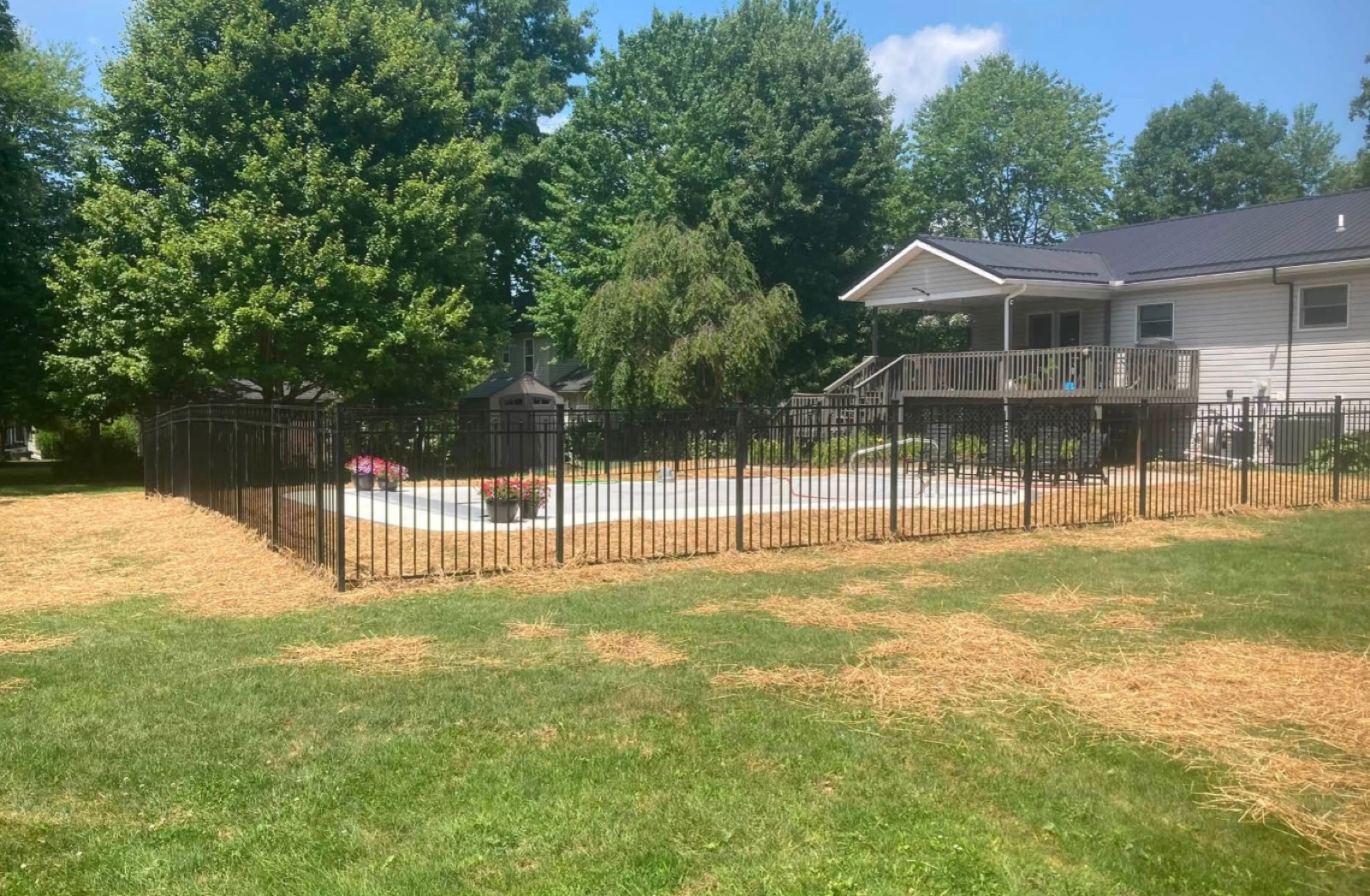Fenced-in backyard pool enclosure