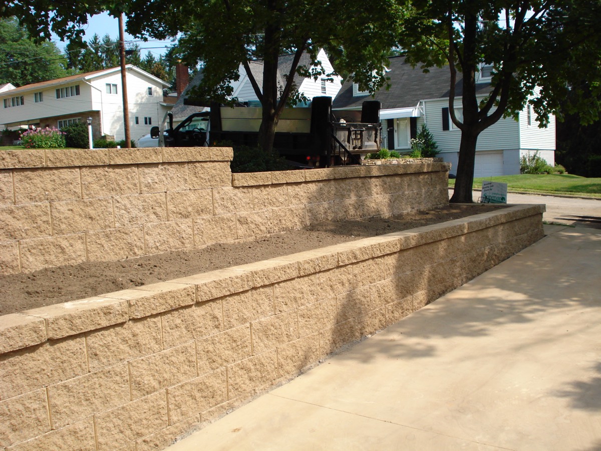 Multi-tier stone retaining wall installation