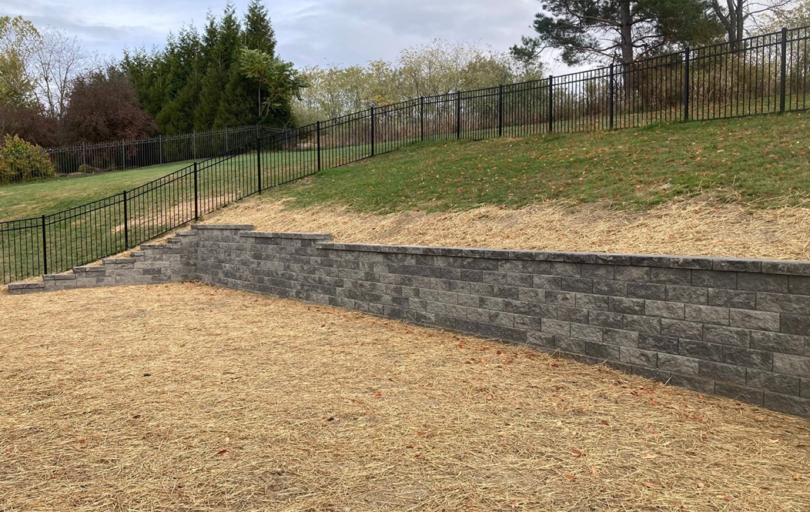Tiered block retaining wall on a graded slope
