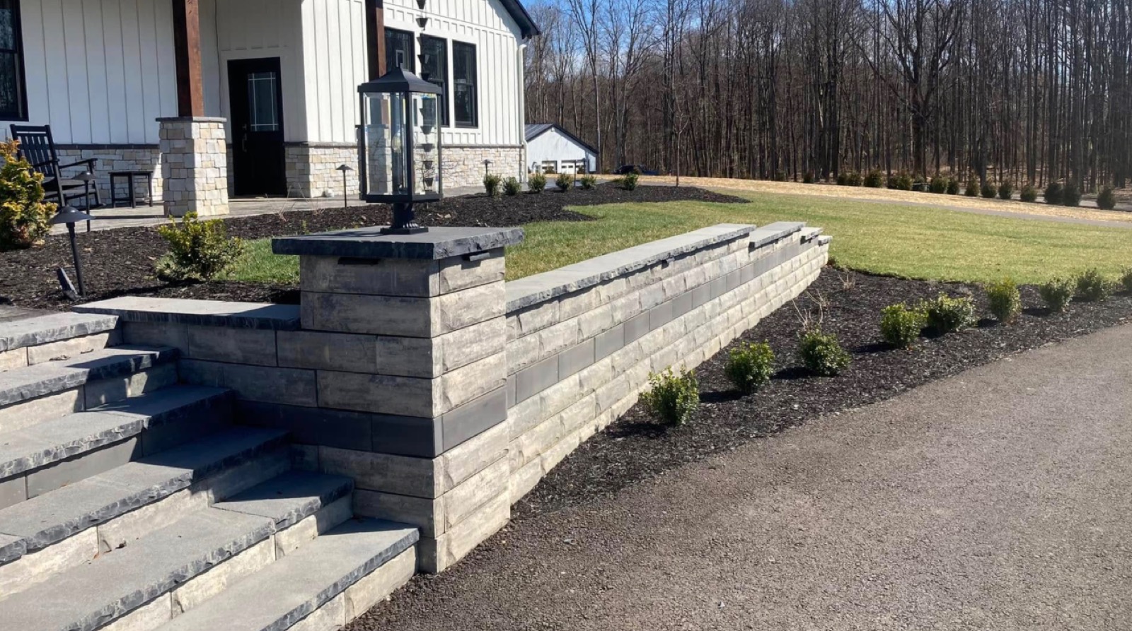 Tiered retaining wall with steps and a lamp post