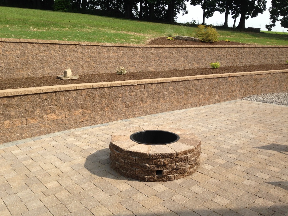 Firepit with a seating wall and paver patio