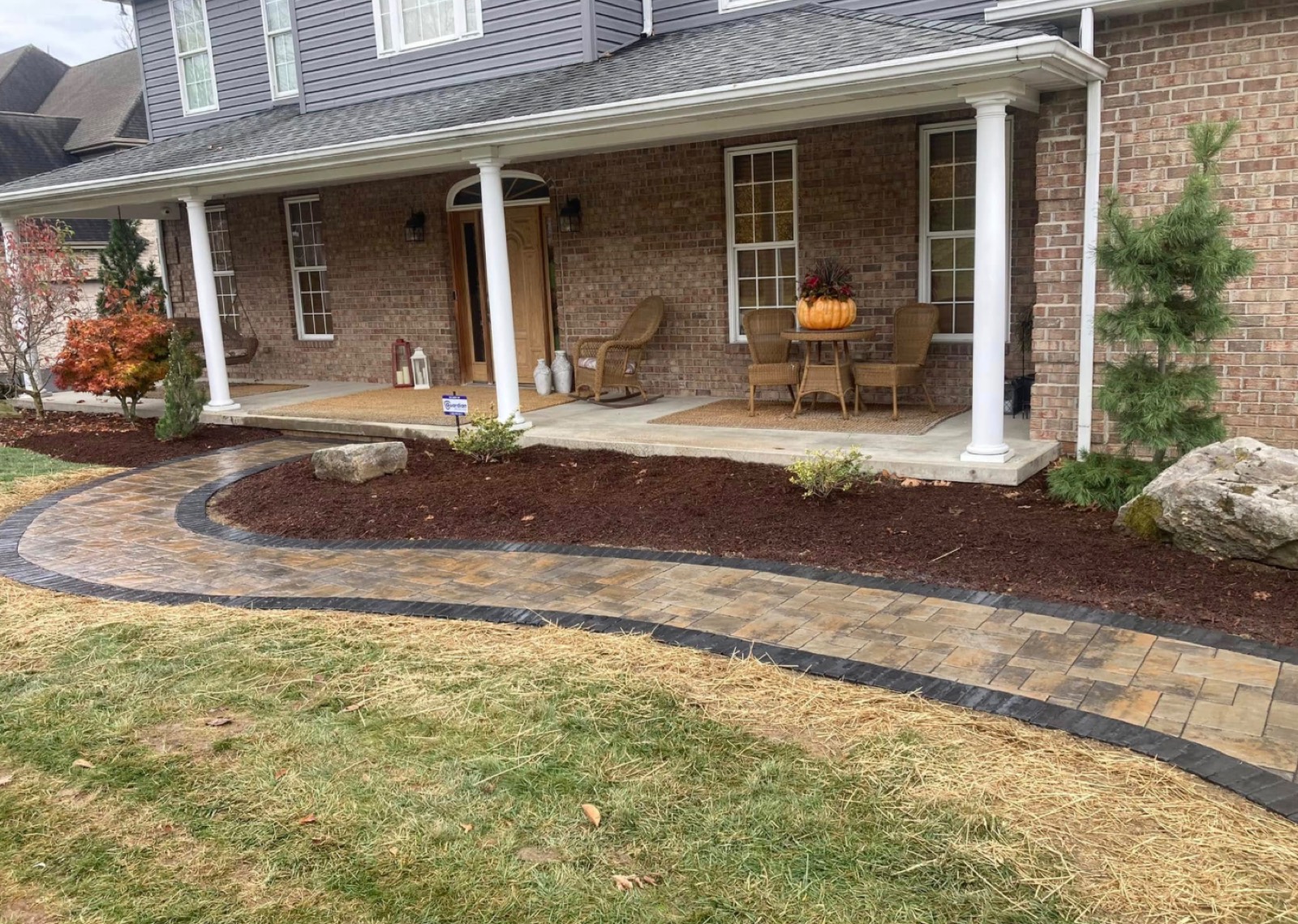 Paver walkway leading to a covered front porch
