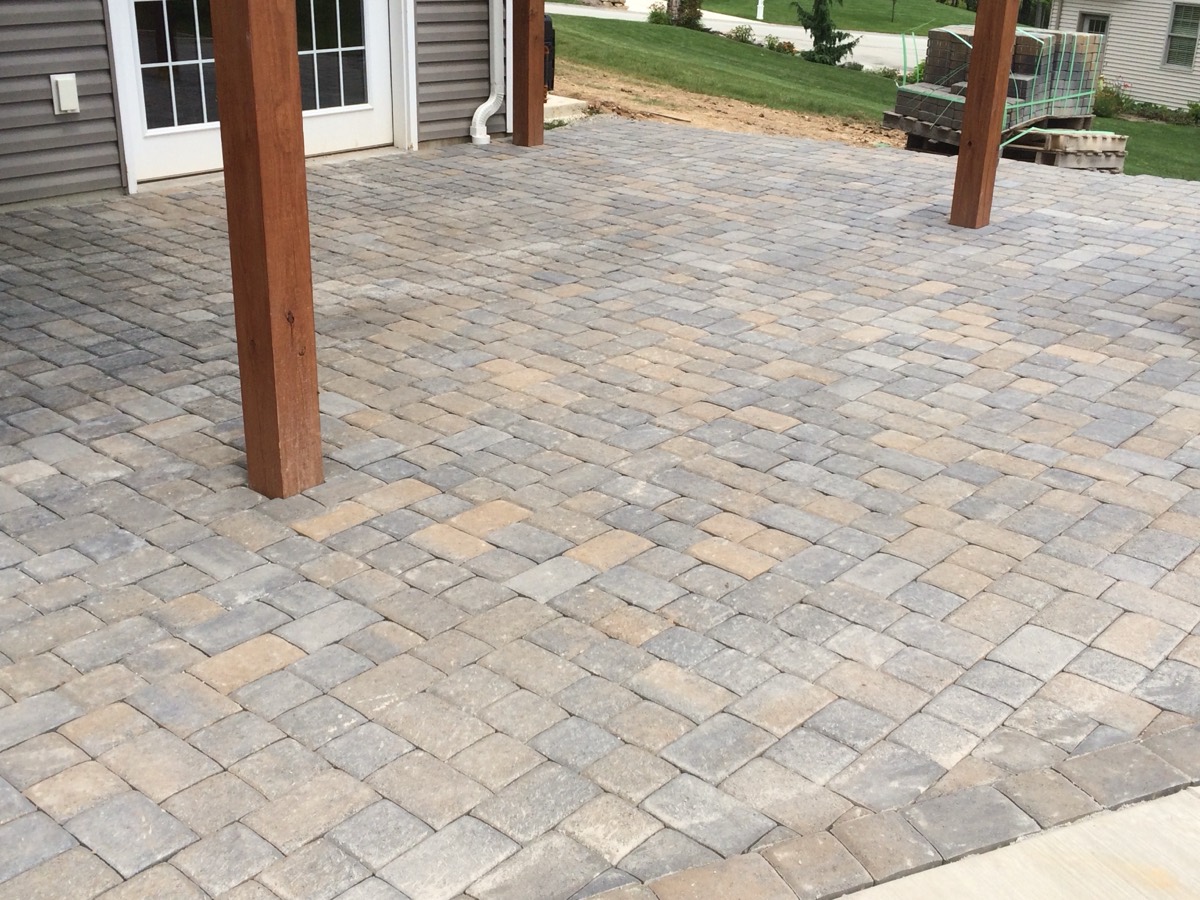 Paver patio beside an in-ground pool