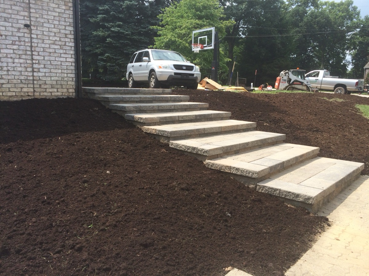 Paver patio with steps and grass plantings