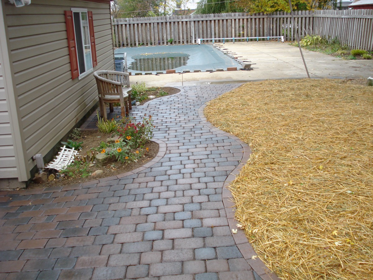 Paver sidewalk around a pool